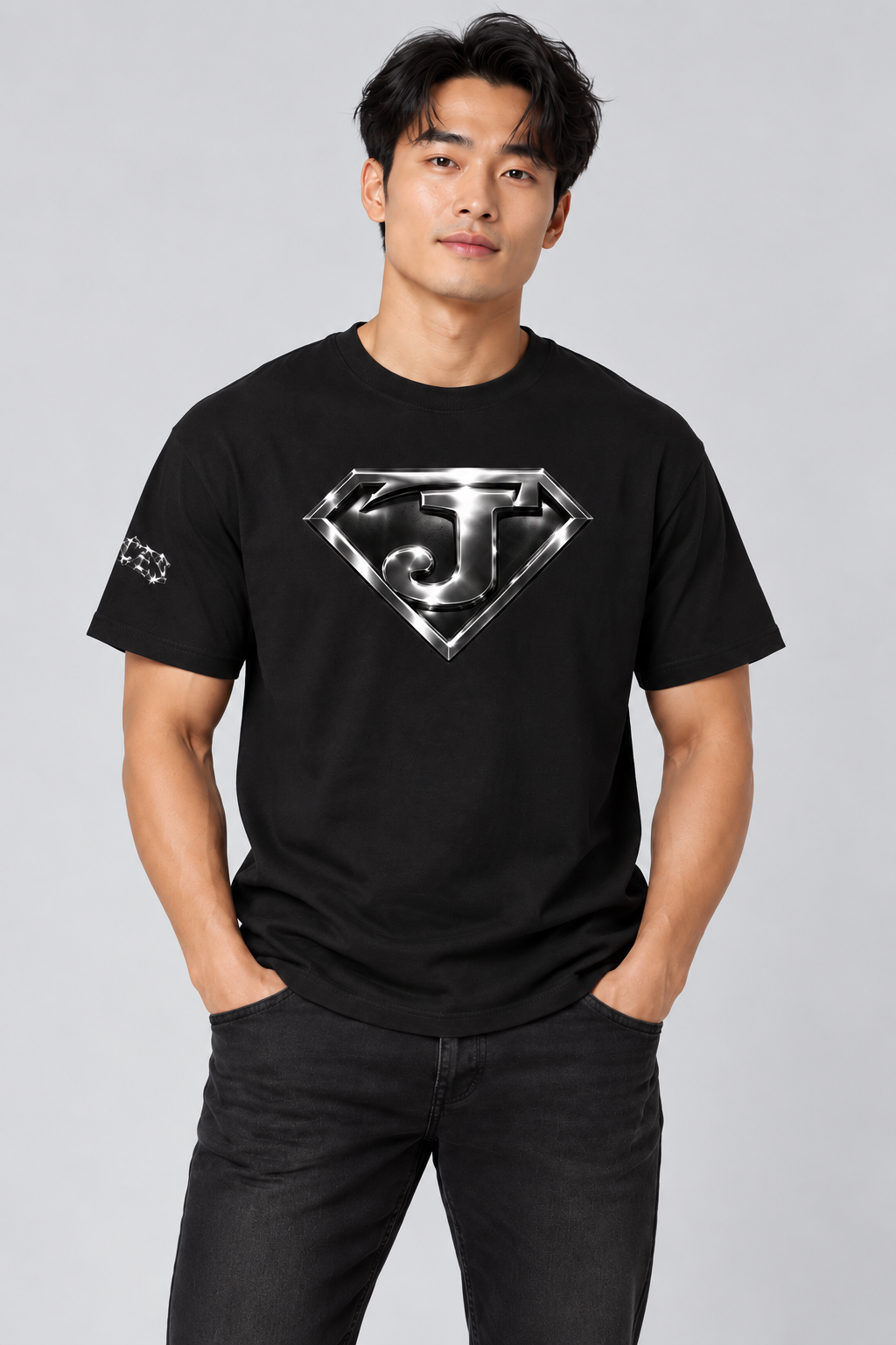 Asian male model wearing the front of the Jesus Is Super T-Shirt in Black.