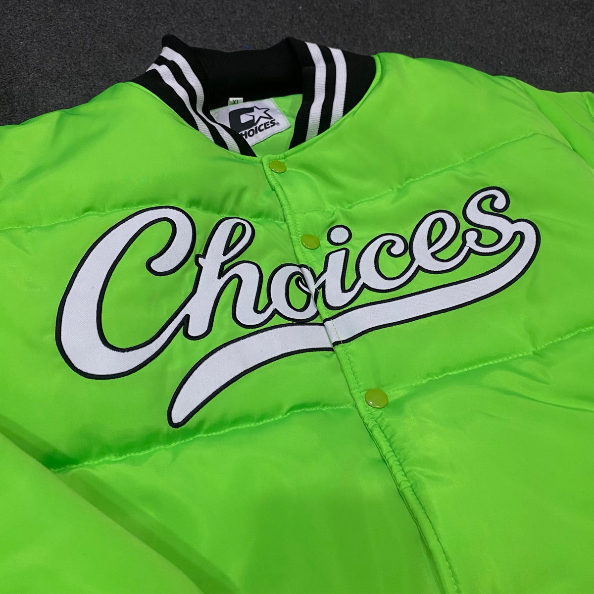 Close-up of Choices lettering on the neon green Started Jacket