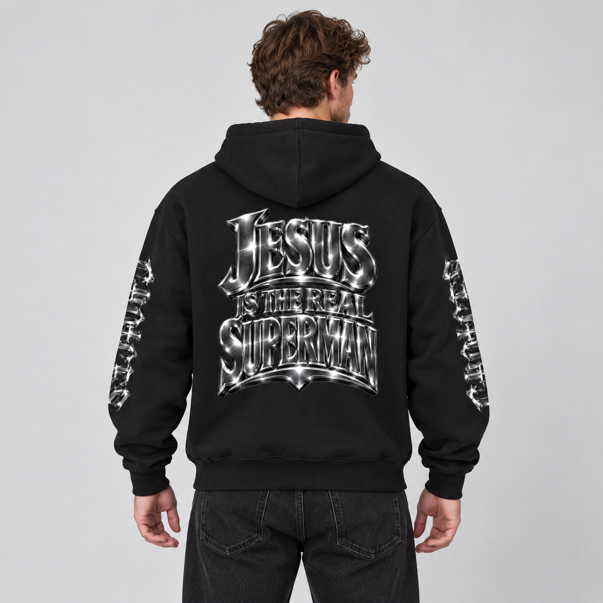 Back view of a model wearing the black Superman Jesus hoodie.