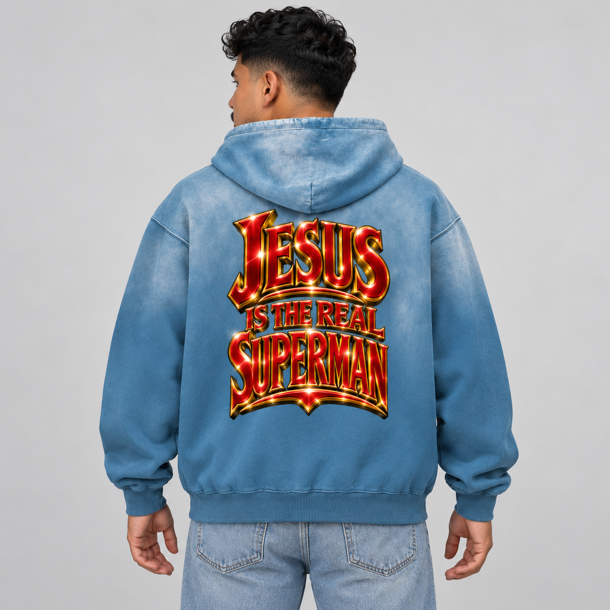 Back view of a model wearing the washed blue Superman Jesus hoodie.